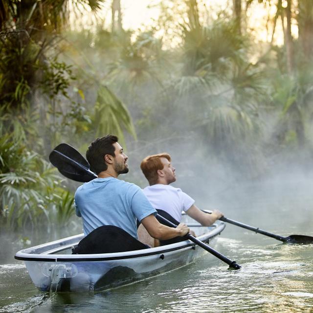 A gay couple kayaking through King's Landing at Wekiva River