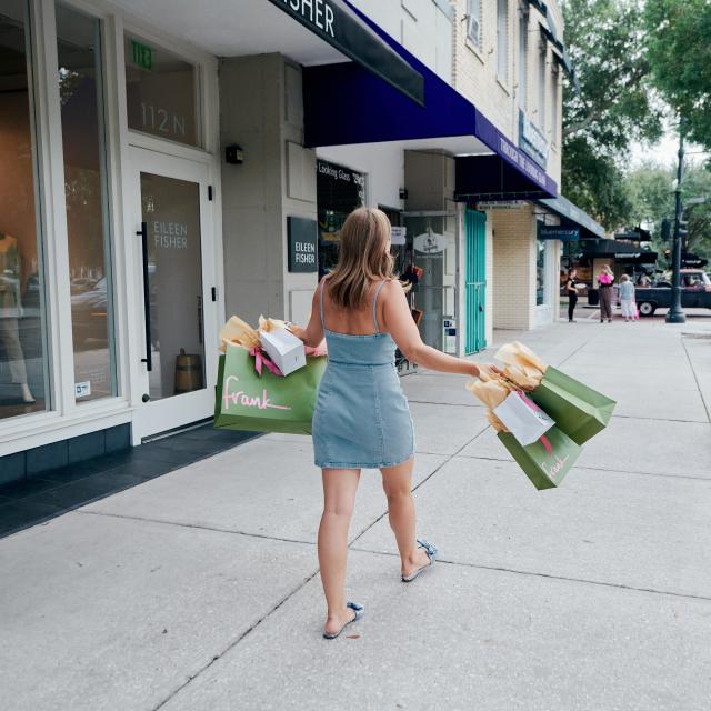 A woman holding shopping bags from Frank store in Winter Park