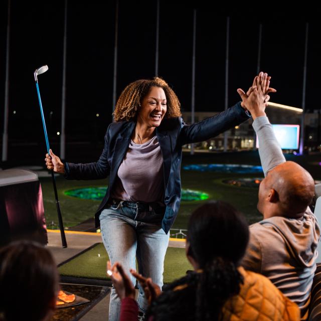 Woman high-five at Topgolf