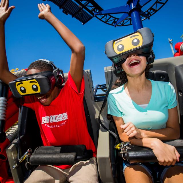 Riders wearing VR headsets enjoy The Great Lego Race at LEGOLAND Florida Resort