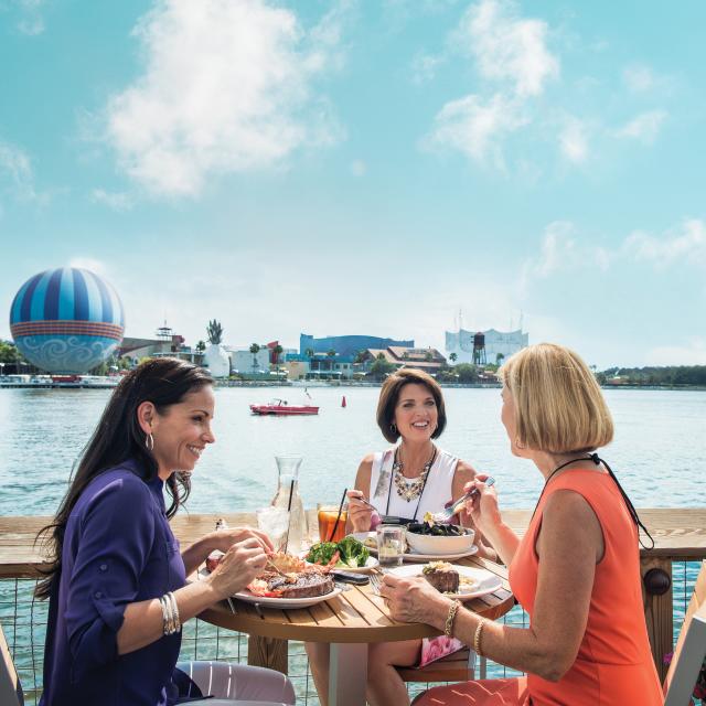 Woman dining at The Boathouse restaurant at Disney Springs