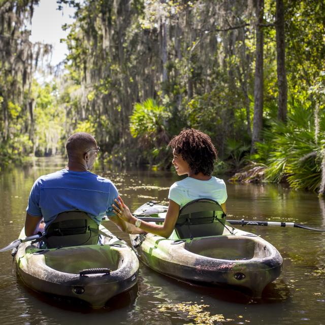 Couple on kayaks on a lake at JW Marriott Orlando, Grande Lakes