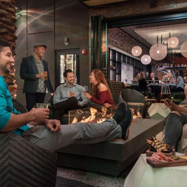 Chroma Modern Bar + Kitchen guests relaxing by firepit