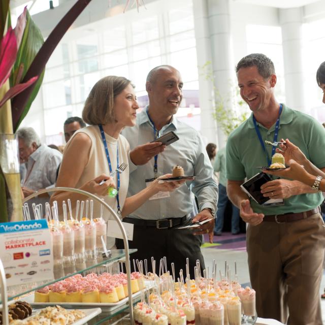 People enjoying desserts at an event at Icon Orlando 360