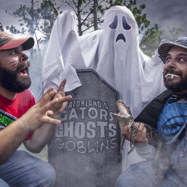Bubba and Cooter in a graveyard with a Ghost at Gatorland's Gators, Ghosts and Goblins Halloween event
