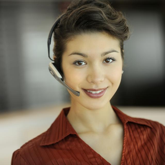 A young businesswoman wearing a headset