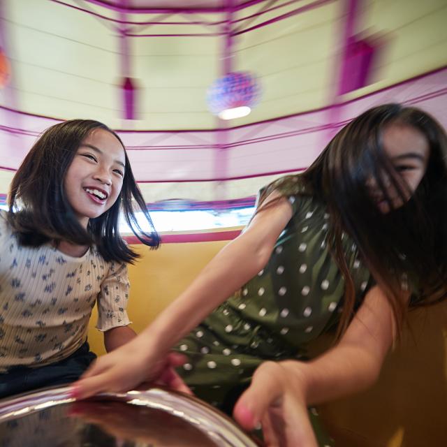 Sisters spinning on the Mad Tea Party ride at the Magic Kingdom in the Walt Disney World Resort