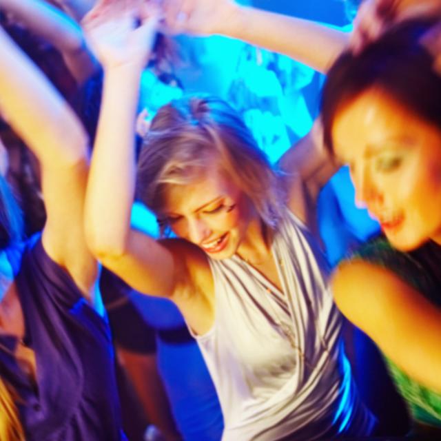 Three young women dancing at a nightclub