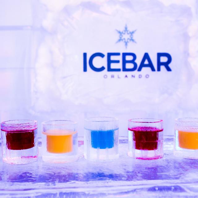 A variety of custom drinks line the ice covered bar at ICEBAR Orlando