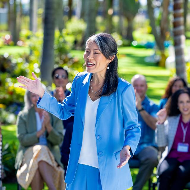 Keynote Speaker at an outdoor event in the sculpture garden at the Lake Nona Wave Hotel