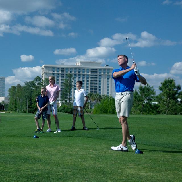 A family playing golf at the Waldorf Astoria Golf Club
