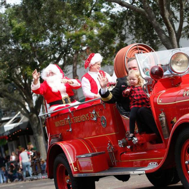 Santa rides a fire truck in the Winter Park Christmas Parade