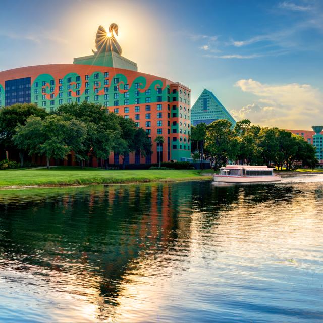 Walt Disney World Swan and Dolphin Resort exterior with boat at dusk