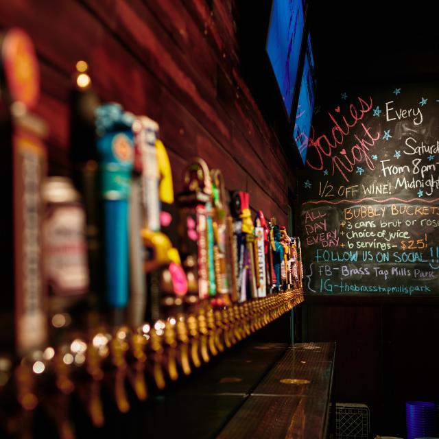 A picture of draft beer taps at The Twisted Handle in the Mills 50 area of Orlando