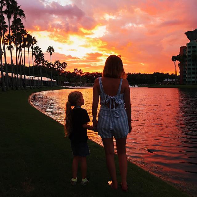 Influencer Katie Ellison and her family watch the sunset on a lake