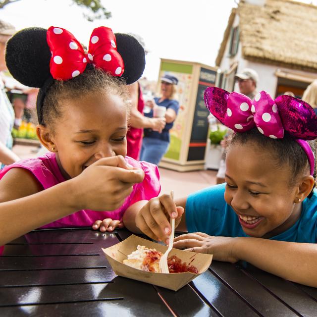 Epcot guests sample tasty bites from the Cider House Outdoor Kitchen during the Epcot International Flower & Garden Festival. The festival features dozens of character topiaries, stunning floral displays, gardening seminars and the Garden Rocks concert series.