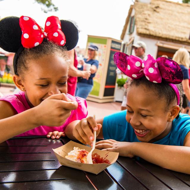 Epcot guests sample tasty bites from the Cider House Outdoor Kitchen during the Epcot International Flower & Garden Festival. The festival features dozens of character topiaries, stunning floral displays, gardening seminars and the Garden Rocks concert series.