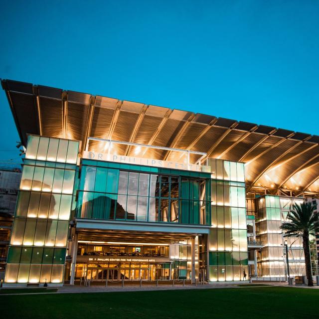 Exterior plaza of Dr. Phillips Center for the Performing Arts in downtown Orlando at sunset.