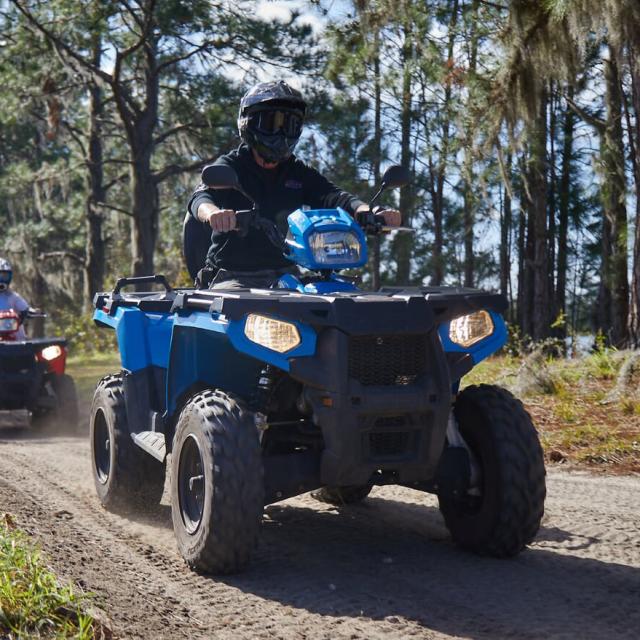 Revolution Off Road group riding trail on ATVs
