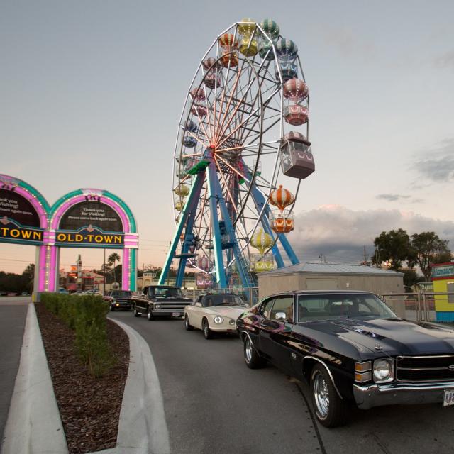 Old Town classic cars and Ferris wheel at dusk