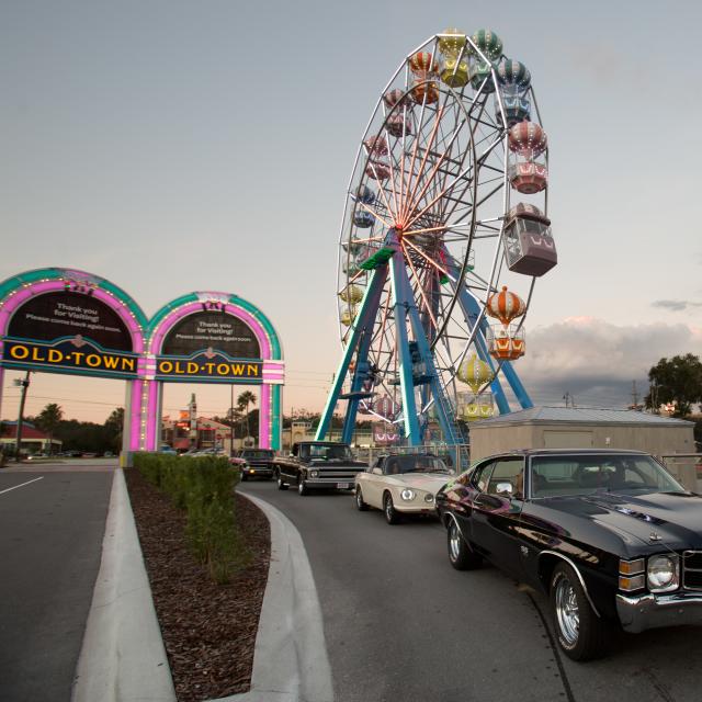 Old Town classic cars and Ferris wheel at dusk