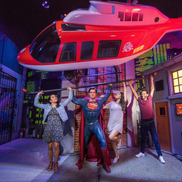 Group poses with Superman at Madame Tussauds