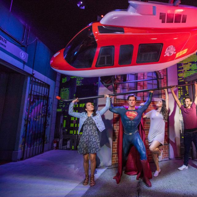 Group poses with Superman at Madame Tussauds