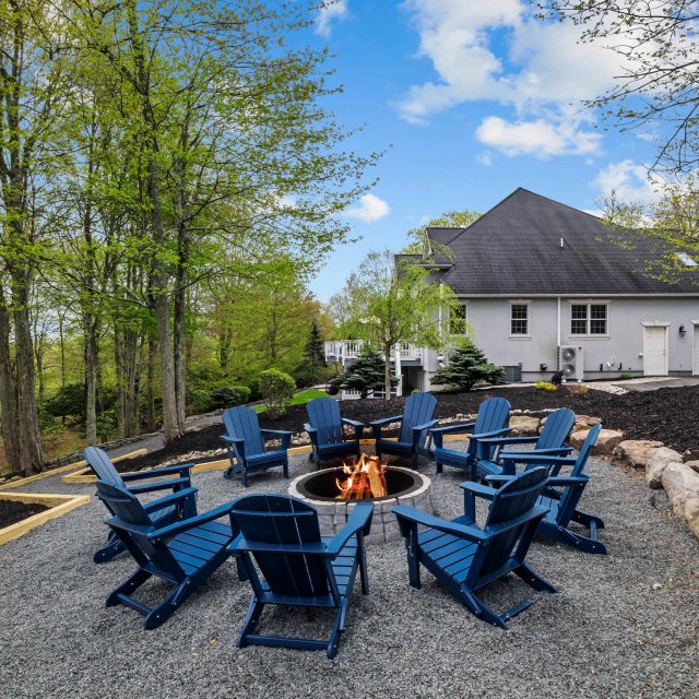 Chairs surrounding an outside firepit at a vacation rental