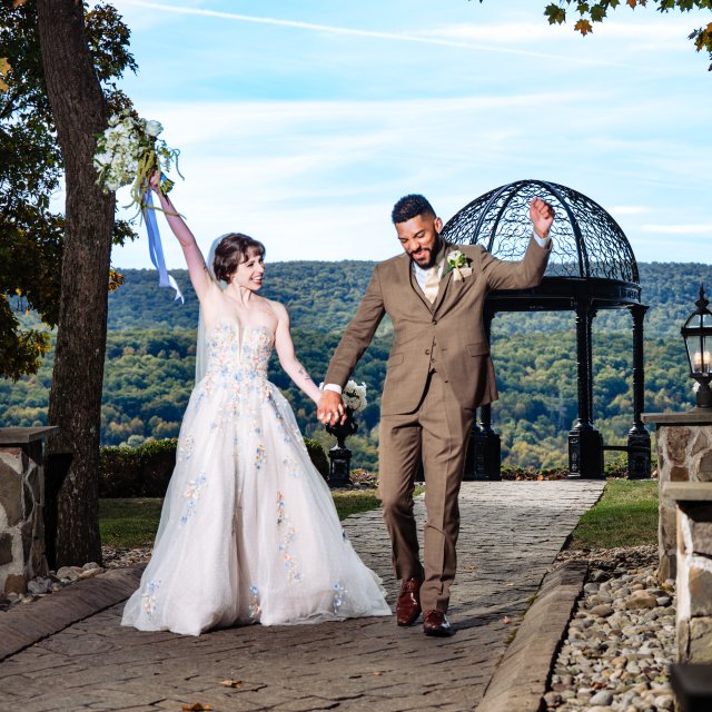 A couple celebrating at their outdoor wedding ceremony