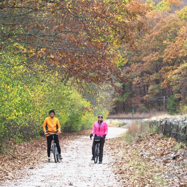 Man and women taking a break from biking on a fall trail