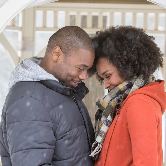 A couple enjoying the snow and being romantic together