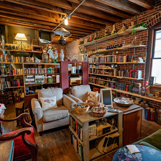 Interior of a bookstore and gift shop with shelves of books and gift items for sale.