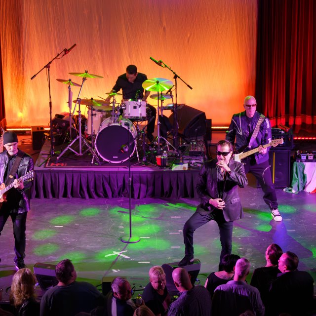A band on stage playing music at the Mauch Chunk Opera House.