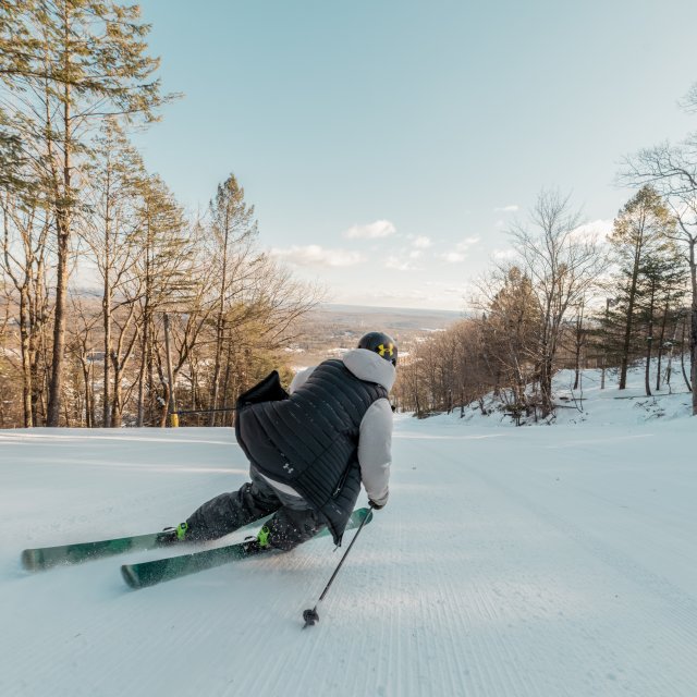 Man skiing down a slope in the winter