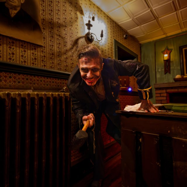 Haunted house actor dressed up in scary attire.