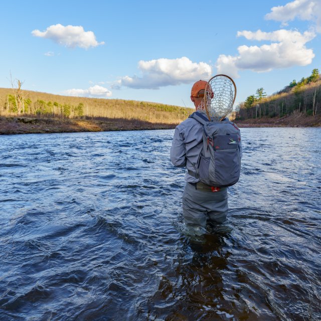 man fly fishing in the water