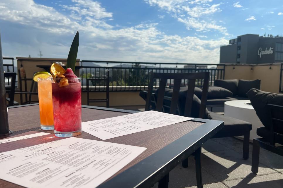 A rooftop bar with two cocktails