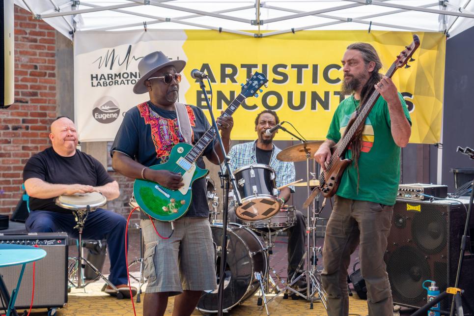 Musicians perform on a stage downtown.