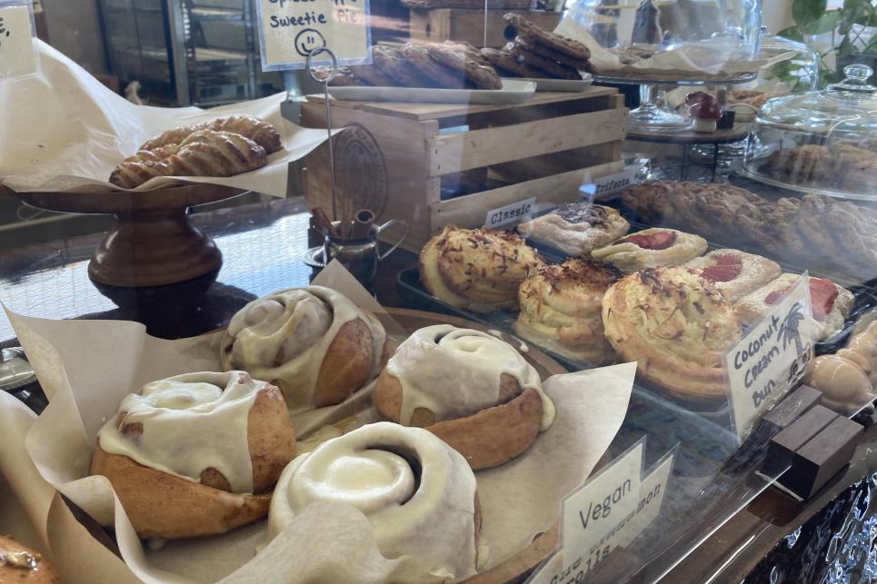 Bakery treats including cinnamon rolls on the counter.
