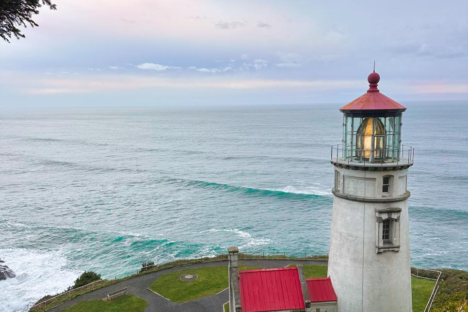 A red-roof lighthouse overlooking the Pacific Ocean