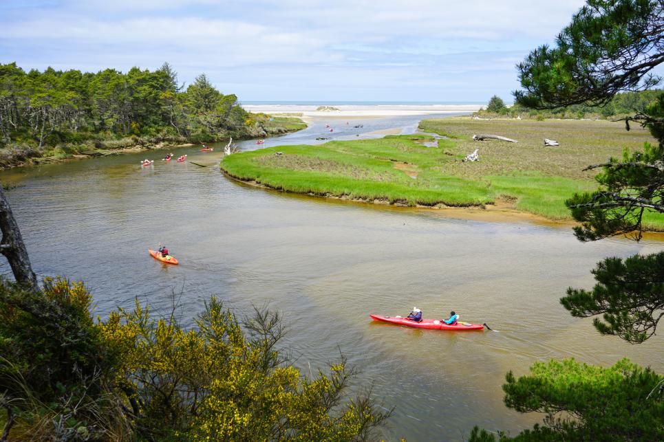 Kayaks on the Siltcoos River before it empties into the Pacific Ocean