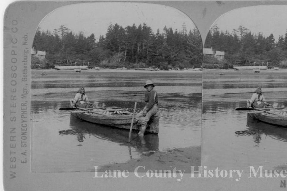 Native couple on a canoe in the Siuslaw River near Florence. Black and white historic photo from 1900s.