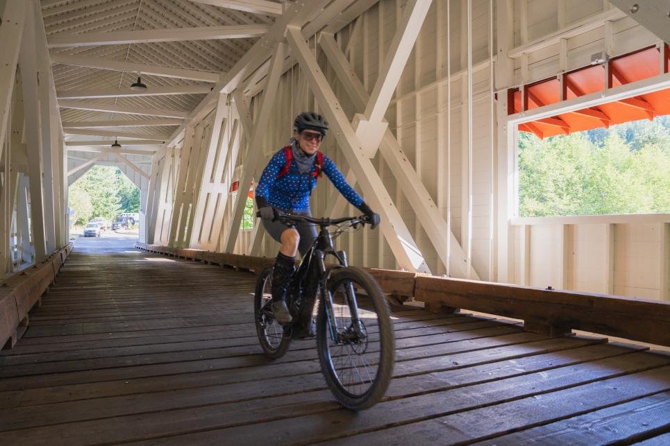 Mountain biking across the Office Bridge in Westfir, Oregon.