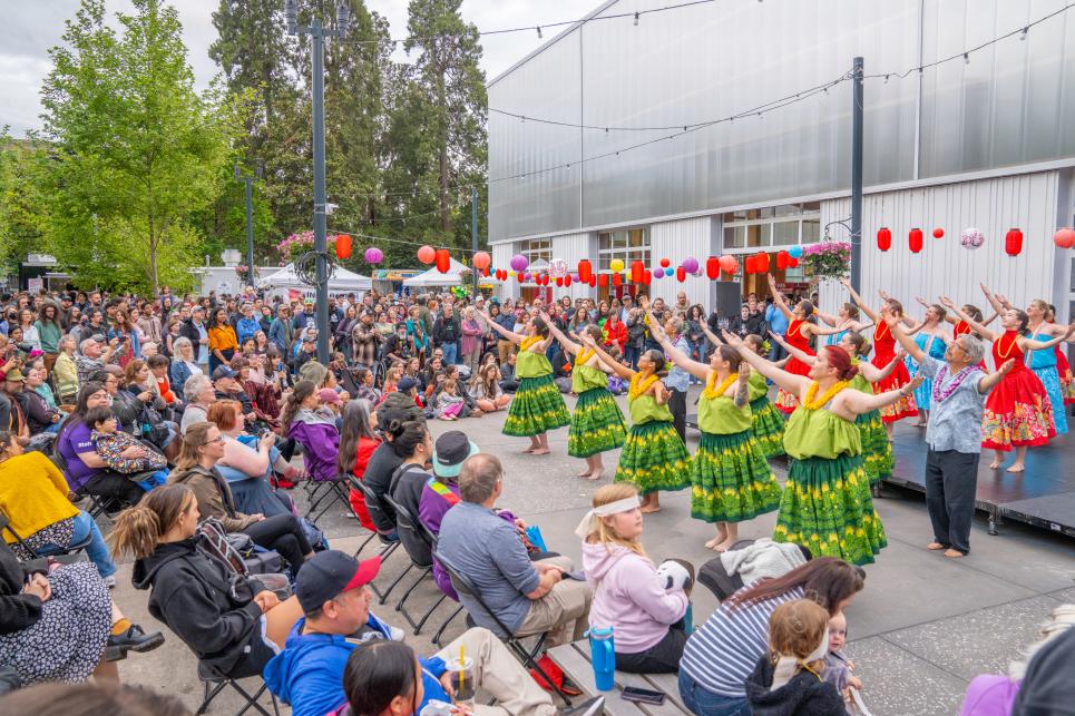 Hula performances outside with a full crowd around the stage.