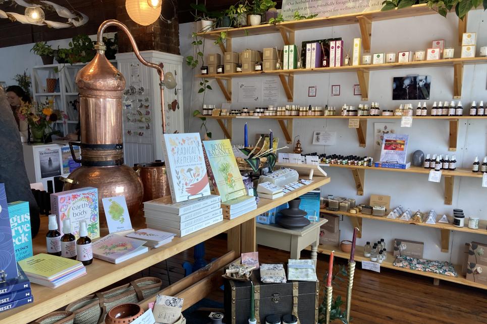 Books, bottles and other products on tables and shelves at the apothecary.