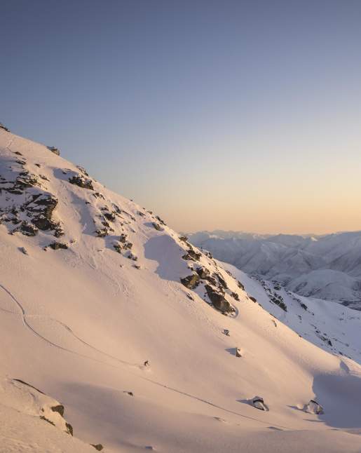 Far shot of person skiing at the Remarkables ski aera at sunrise