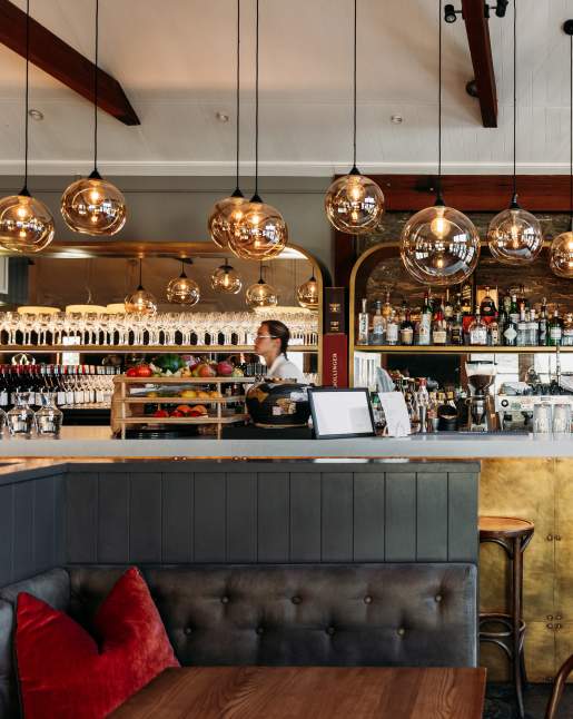 Interior shot of Aosta Restaurant - modern design with liquor bottles in the background