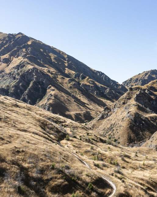 Wide view of a mountain bike trail through striking rugged mountains