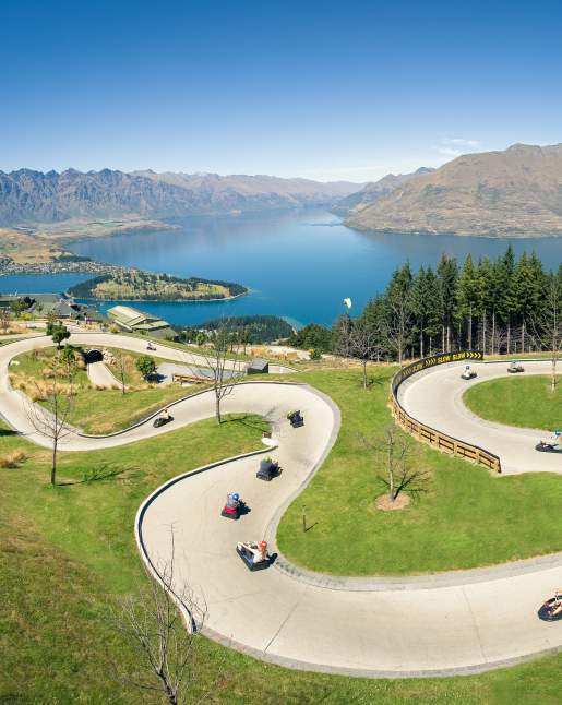 People on the Skyline Queenstown luge with elevated views of Queenstown