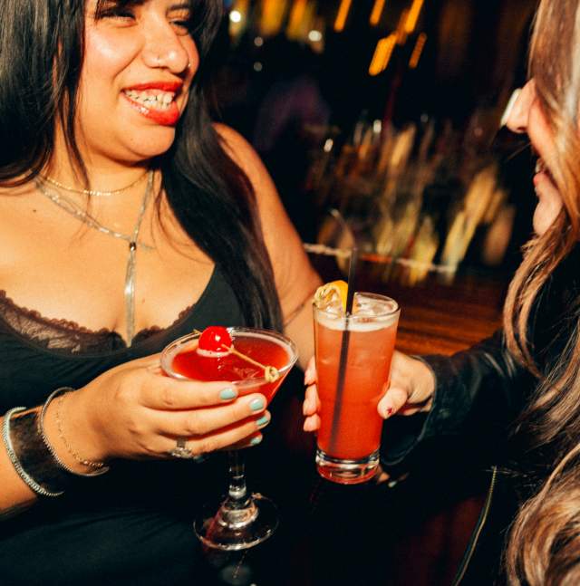 Two people having a drink at a bar.
